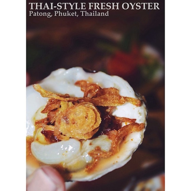 Fresh oyster topped with burnt chilli sauce and some fried onions...