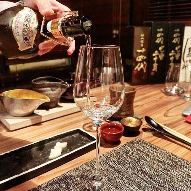 Embracing the rainy evening savoring artisanal sakes at a sake tasting at Kakure!