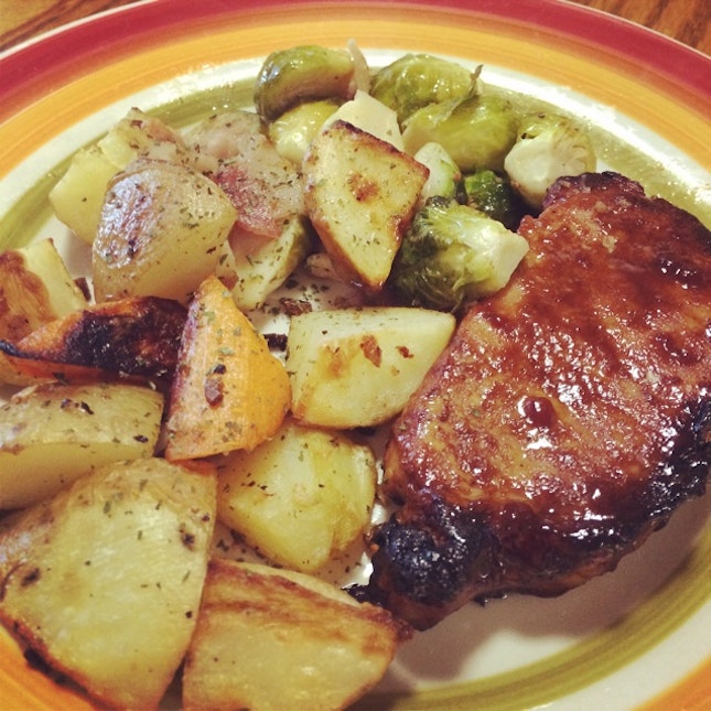 Baked Pork Chop With Garlic Potatoes And Bacon Brussels Sprouts