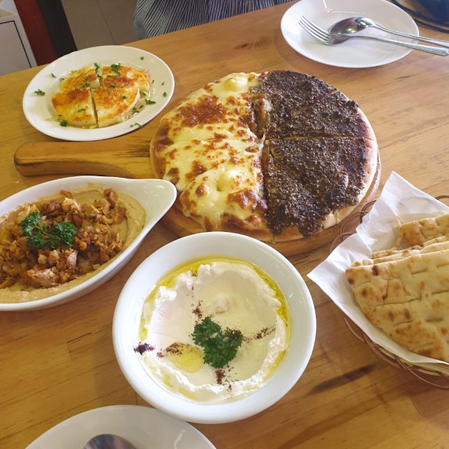 Manaquis with Cheese + Za'tar, Hummus with Chicken, Grilled Halloumi, Labneh ($64.02)