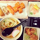 Handmade udon set with sushi and fried chicken.