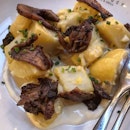 Yukon potato salad in sour cream topped with mushrooms