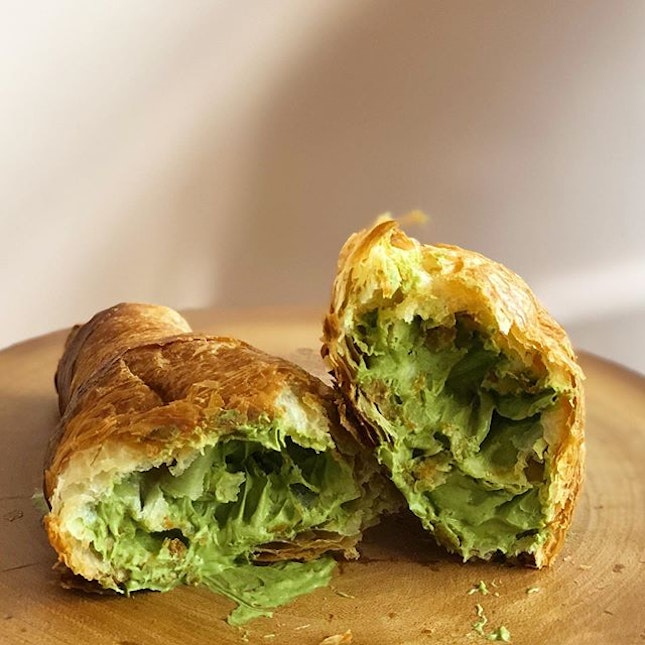 [Matcha Croissant-$5]

Not exactly the most aesthetic shot, but this was one delicious green mess of a croissant 😌😋 Glad that I managed to snag this croissant which is available for a limited time only (today's the last day!!) after missing my chance last weekend because I was overseas 😅 
The croissant was so surprisingly good??