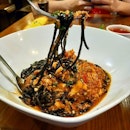 Squid ink tangielle with crab meat tomato sauce and chilli.