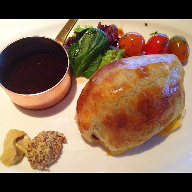 Beef Wellington , 8-ounce ( Australian filet mignon with mushroom duxelle, wrapped in Parma Ham, topped with Foie Gras & wrapped with puff pastry. Served with red wine Madeira sauce )