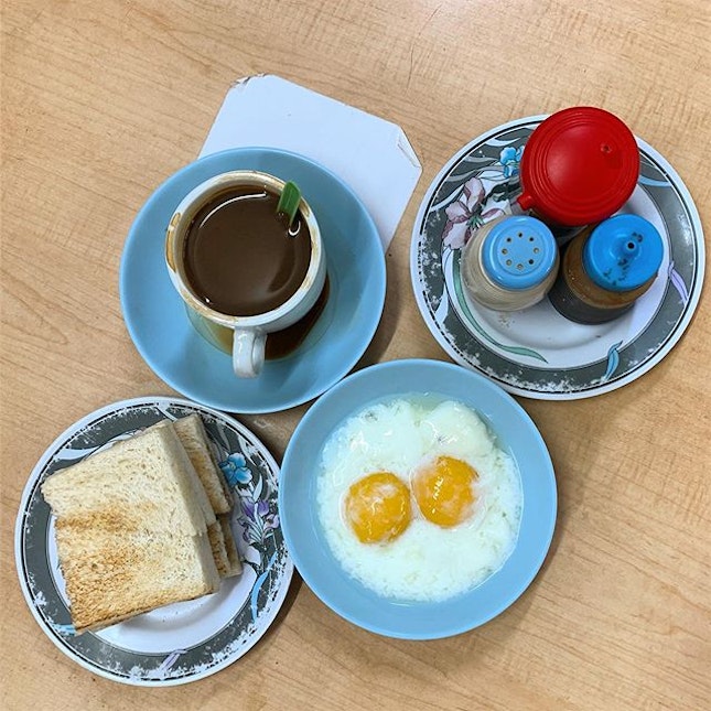 Traditional breakfast of butter toast and soft boiled eggs.