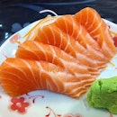 Yummy sushi place near my house slices pieces of sashimi from one whole bloody piece of salmon in front of me.