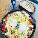 Baked eggs, minced beef, chorizo and more sizzling in a pan.