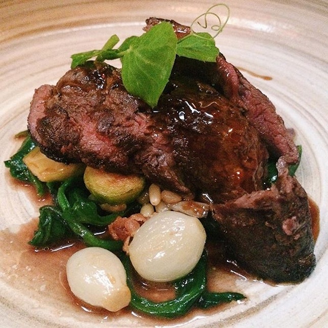 Kangaroo fillet from Open Door Policy – roast brussels sprouts, pine nuts and baby onions, sautéed warrigal greens and vinegar jus.