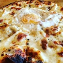 The Eggcellent  Roasted Garlic Cream, mozarella, bacon bits, softly cooked egg, parmigiano-reggiano cheese, crushed black pepper  The sous vide egg that is comfortably nestled on the top makes the pizza looks more appetizing and instagram-worthy.