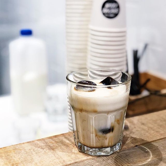 Stronger and stronger - an empty cup filled to the brim with espresso ice cubes, with milk added upon service.