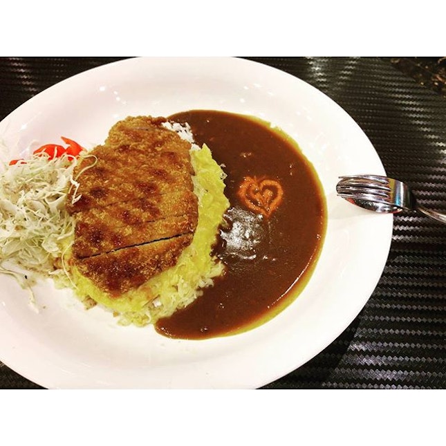 A plate of monster curry with cheese omelette and pork katsu for $17.80++.