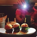 The things foodies do for that perfect instagram shot of the heavenly mini wagyu foie gras burgers.