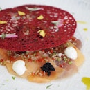 Carpaccio ($18) – stunning red coral tullie revealing a bed of braised daikon radish, fish slices, lime mayo and black fish roe with citrus Asian dressing and herb oil, drizzled with lime zest.