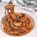 Seafood Arrabiata, Spicy tomato sauce, tossed with al-dente spaghetti along with a smorgasbord of seafood such as sweet clams, crunchy prawns and chewy squid rings.