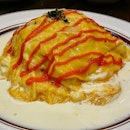 Mentaiko Omu Rice ($13.99)

Ketchup fried rice enveloped in fluffy omelet and bathed in cream sauce.
