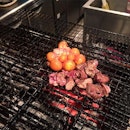Chicken innards with eggs cooked on a charcoal grill.