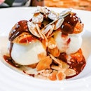 Choux Buns with Vanilla Ice Cream
Häagen-Dazs vanilla ice cream, sandwiched between two exquisite choux puffs and drizzled with chocolate sauce and garnished with roasted almonds.