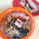 Enjoying the silky smooth Kueh Teow from Lai Heng topped with some crispy roasted pork from the next stall.