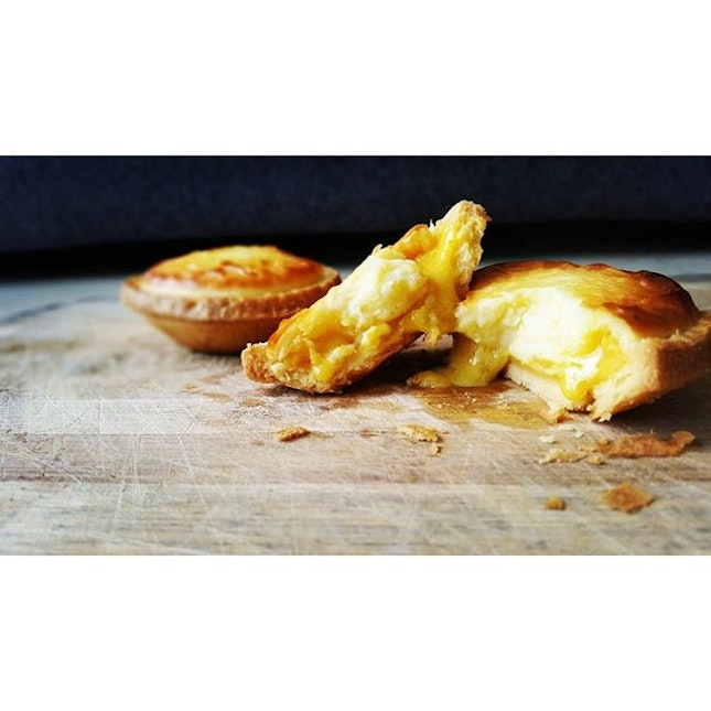 savoury Salted Egg Lava oozing out from a sweet and fluffy cheese tart that has a buttery and flakey crust...