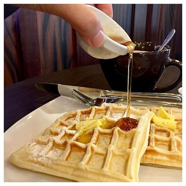 Classic Waffle topped with butter, drizzled with syrup, and dashed with granulated sugar.