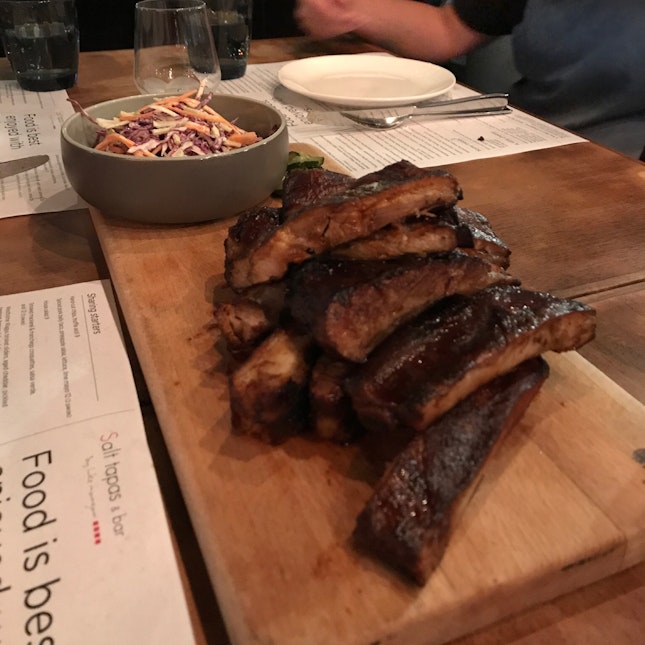 Whole Pork Ribs in a Miso, Honey-Soy Glaze with sides of Apple & Wasabi Slaw and Pickled Cucumber ($45)