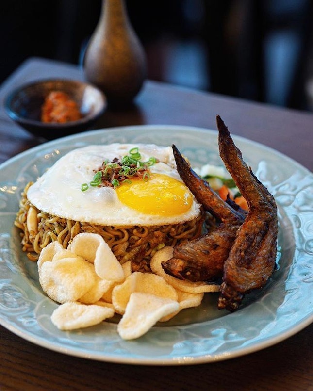 [Fat Chap] - The “Bakmie” Goreng ($15) comes with crispy prawn crackers, squid, achar and a sunny side up egg sitting atop.
