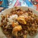 famous char kway teow topped with crab bits