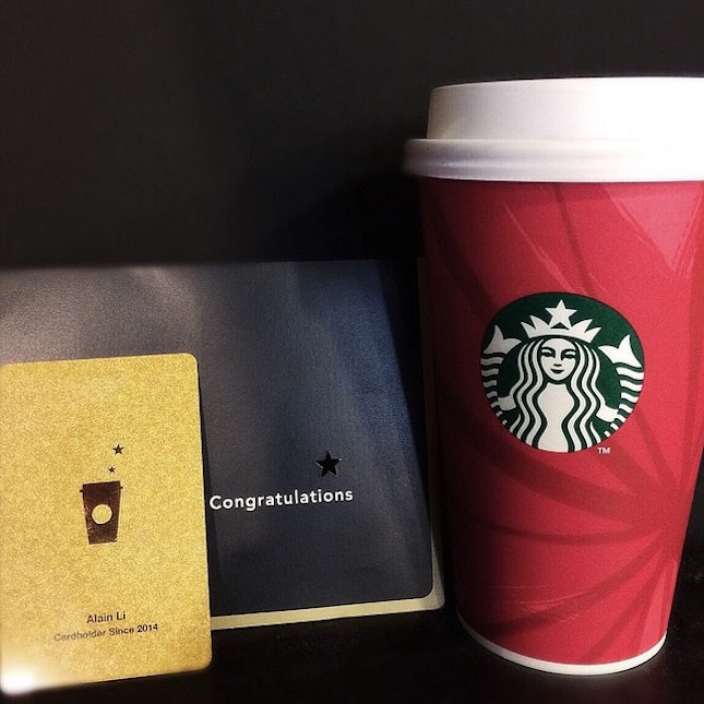 Enjoying the cheap thrill and free perks from Starbucks with complimentary beverage and personalized gold card bearing my name.