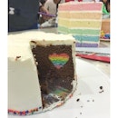 The top layer of the birthday cake - chocolate cake with a rainbow heart in the centre.